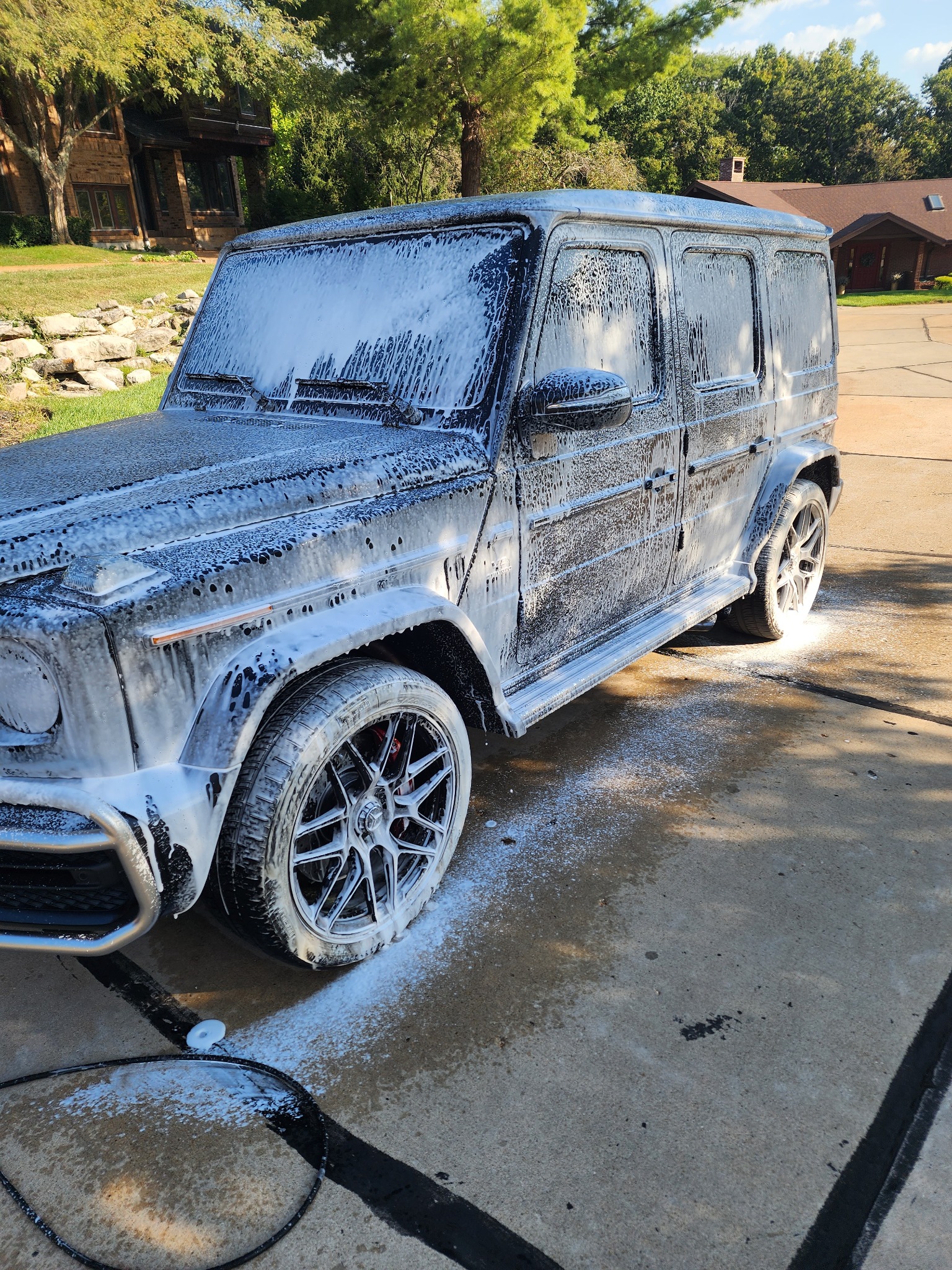 Black SUV covered in foam during a Dossome wash