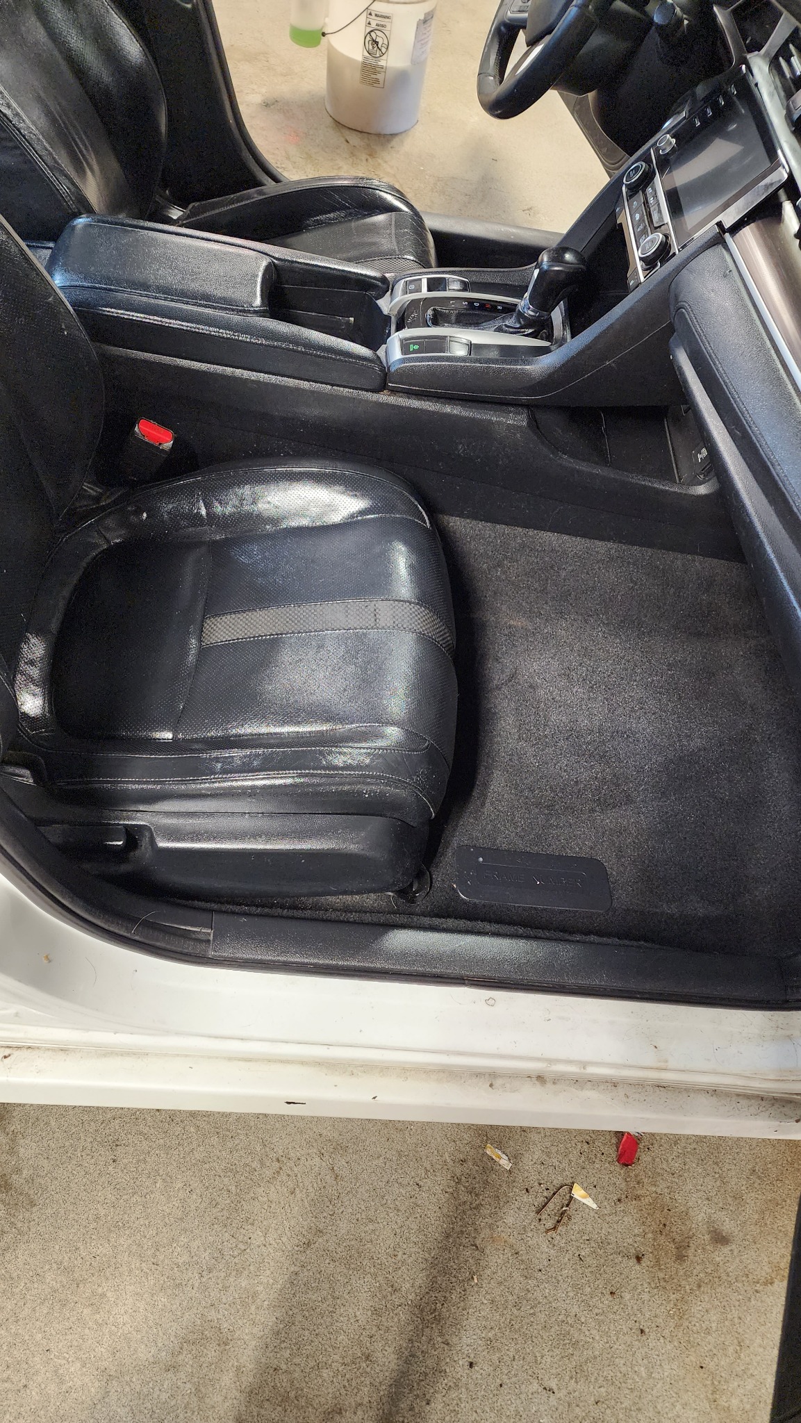 Clean driver's seat and center console after detailing