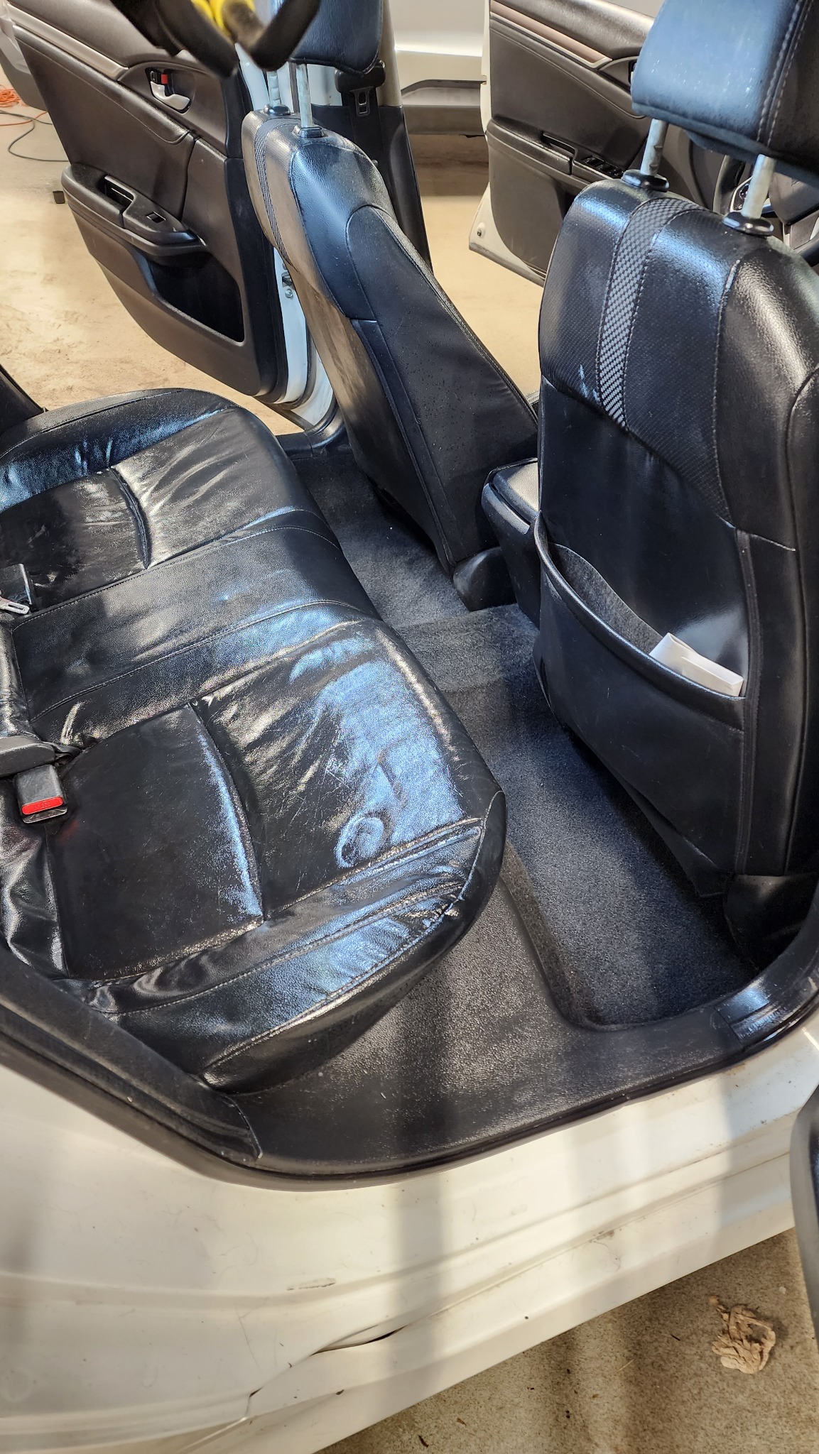 Clean black leather vehicle interior after detailing